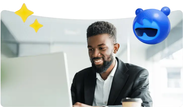 A person is working on a computer and smiling